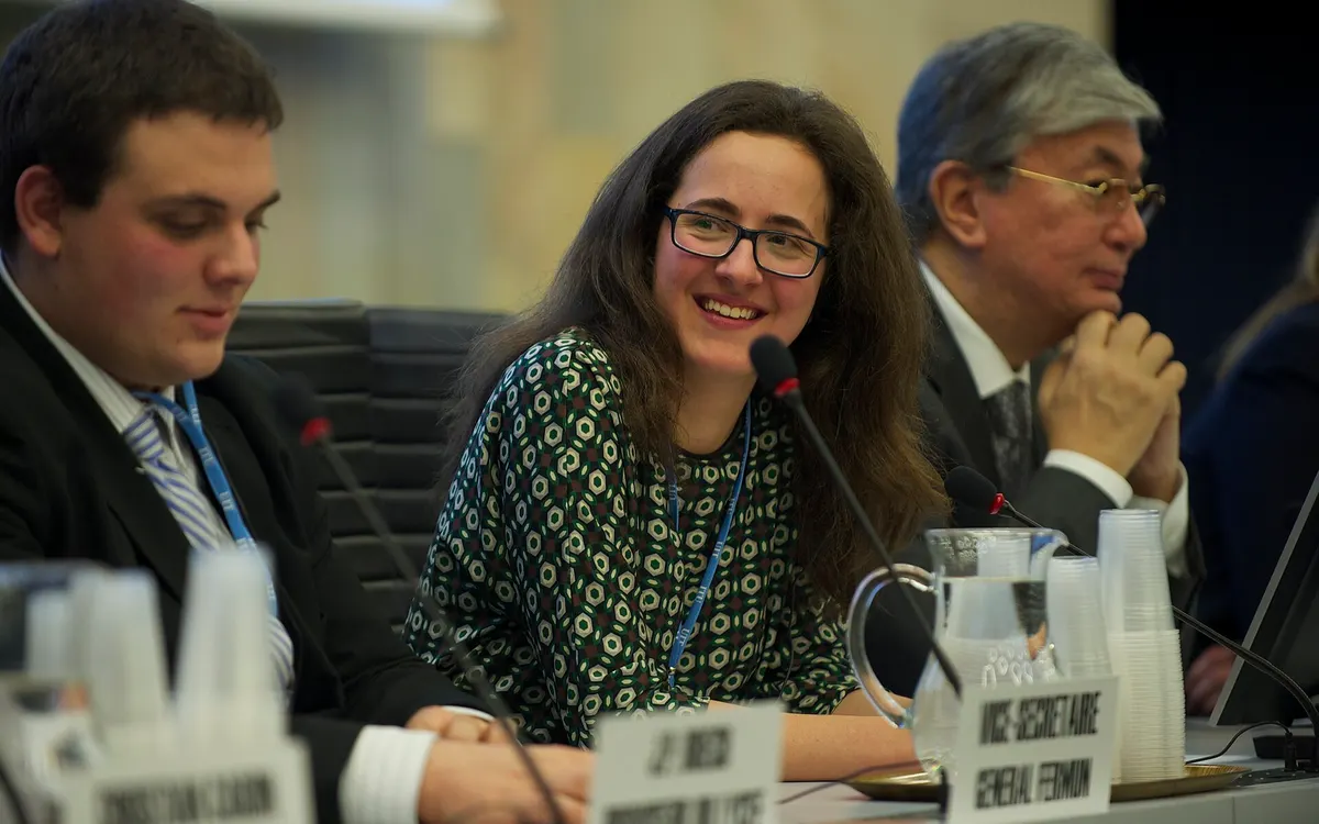 Students and the Director-General of the UN Office at Geneva seated together at a Model UN conference held at the International Telecommunication Union