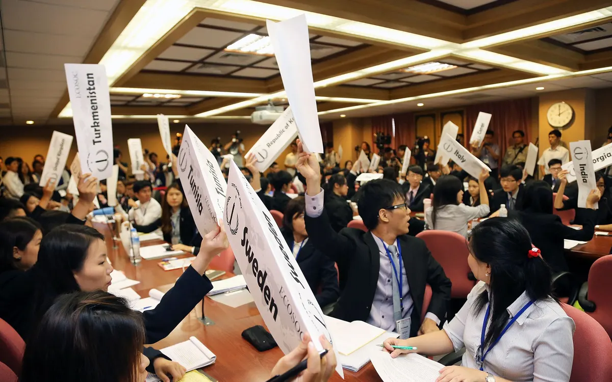 Students at a Model United Nations conference at National Chengchi University in Taipei holding up large country placards